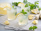 Glasses of lemon water with min leaves and lemon slices